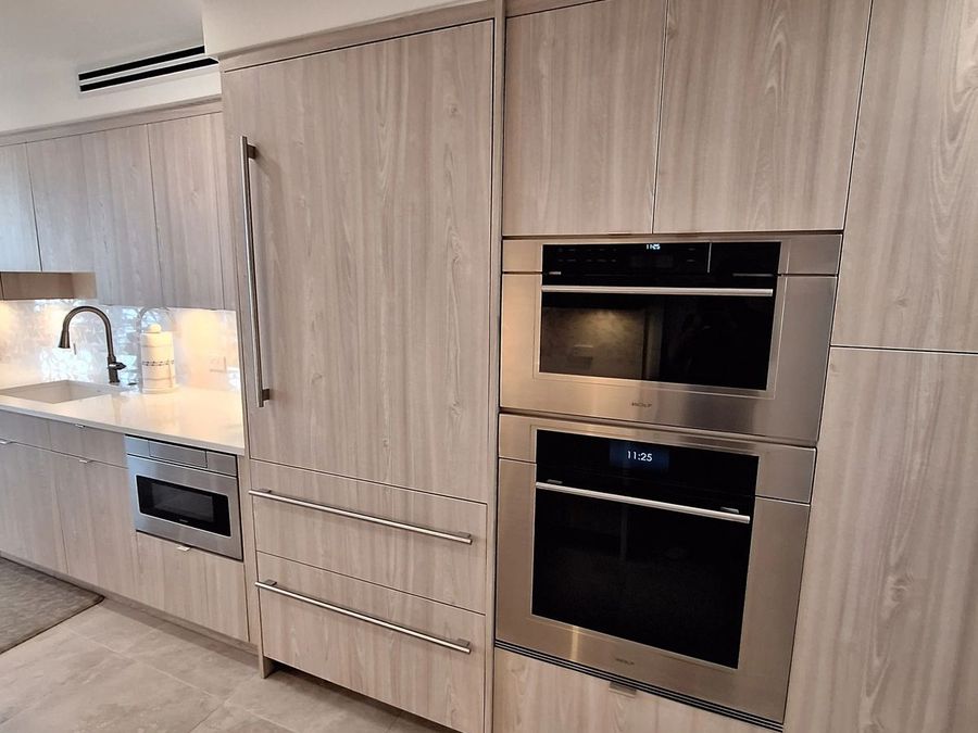 Same completed kitchen, appliance wall with built-in ovens